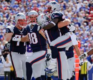 New England Patriots' Dion Lewis, right, celebrates with Rob Gronkowski (87) after rushing for a touchdown during the first half against the Bills, (AP Photo/Bill Wippert)