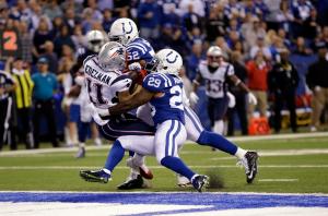 Julian Edelman scores as he's hit by Colts strong safety Mike Adams (29) and inside linebacker D'Qwell Jackson (52) . (AP Photo/AJ Mast)