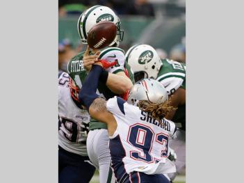 Jabaal Sheard (93) strips the ball from New York Jets quarterback Ryan Fitzpatrick (14) (AP Photo/Seth Wenig)