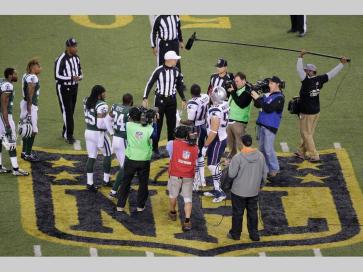 The officials meet New York Jets' Darrelle Revis (24), teammate Calvin Pryor (25) and New England Patriots' Matthew Slater (18) and teammate Rob Ninkovich (50) for the coin toss before the overtime period resulting in highly questionable Patriots decision (AP hoto/Peter Morgan)