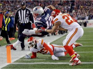 Kansas City Chiefs free safety Husain Abdullah (39) and defensive back Tyvon Branch (27) push Tom Brady (12) out of bounds short of the goal line (AP Photo/Steven Senne)